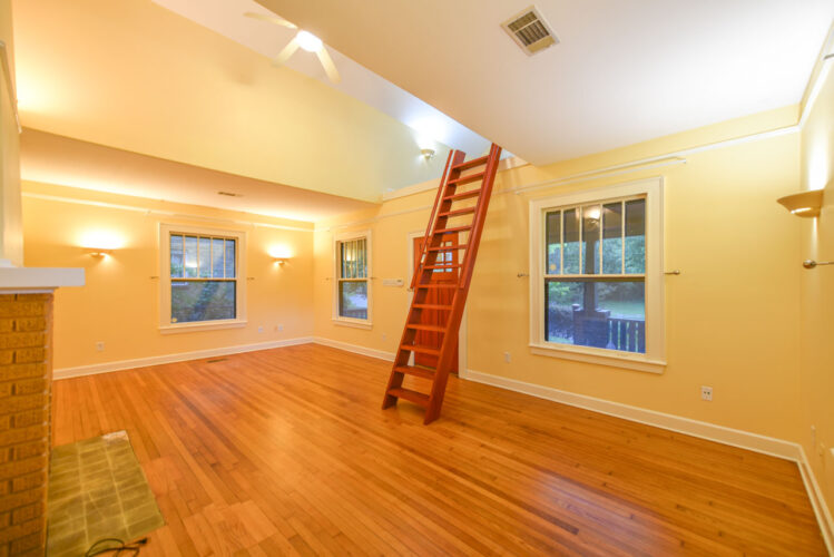 Large living room with loft and skylights.